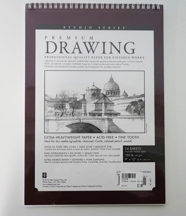 A spiral-bound drawing pad with a dark maroon cover labeled