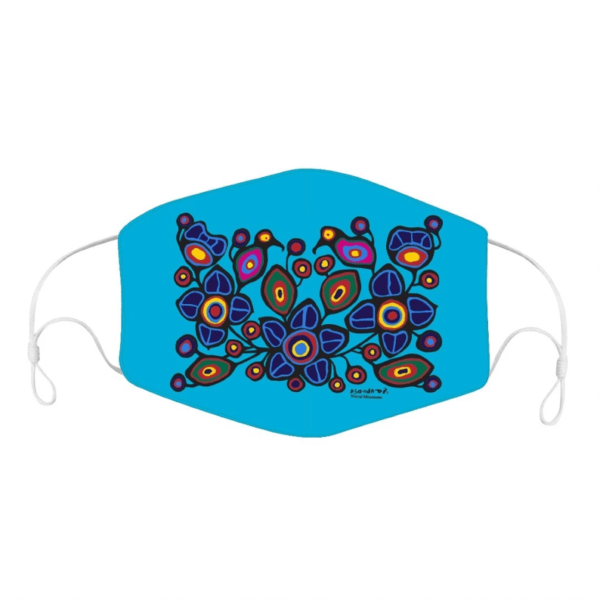 A Mask with Norval Morrisseau Artwork featuring an Indigenous-inspired design on a bright blue background. The colorful pattern includes abstract shapes in shades of purple, blue, red, orange, and yellow, arranged in a visually striking composition. The mask has adjustable ear loops.