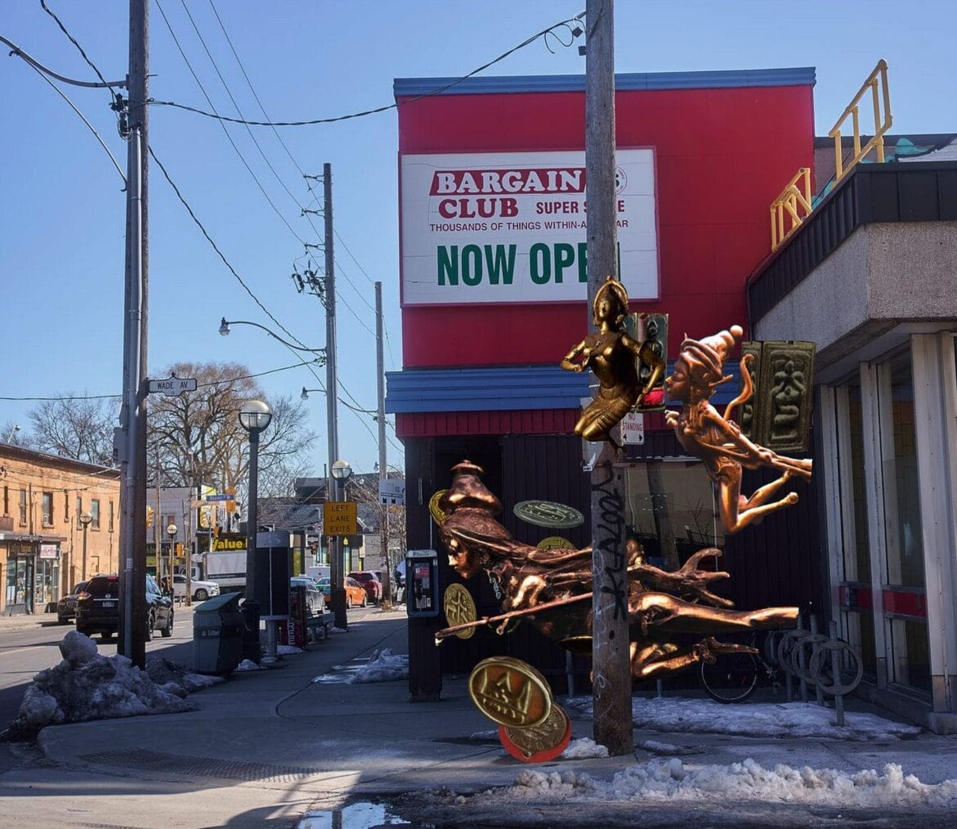 A vibrant street scene shows a red building with a