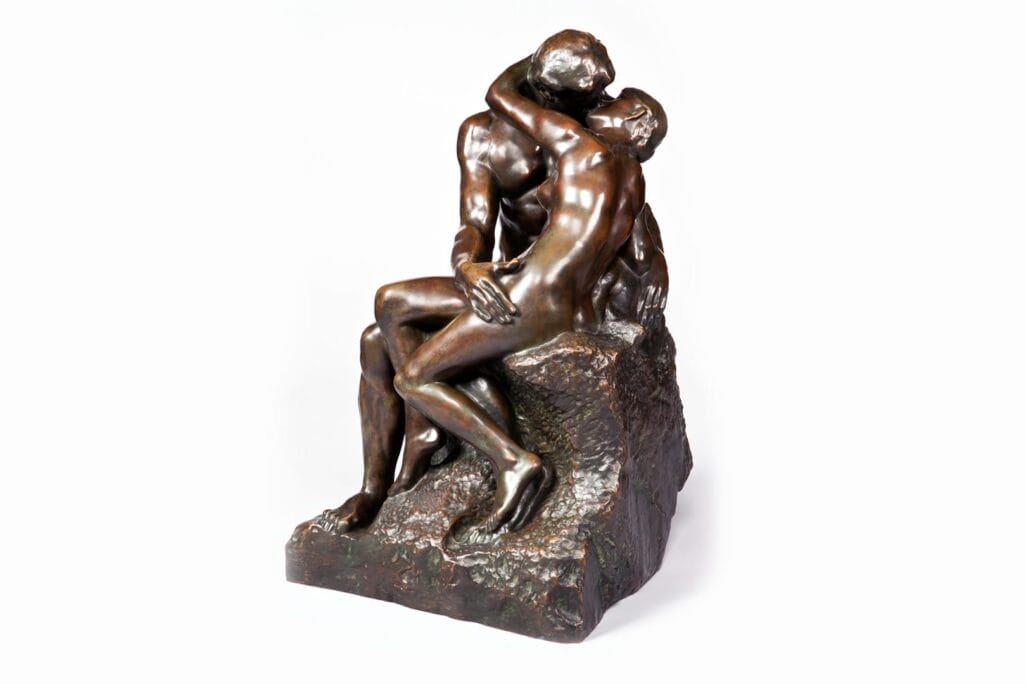 On Free Admission Day, admire a bronze sculpture of two intertwined figures seated on a rock, engaged in a passionate embrace. The detailed artistry beautifully captures their emotional connection and fluid motion.