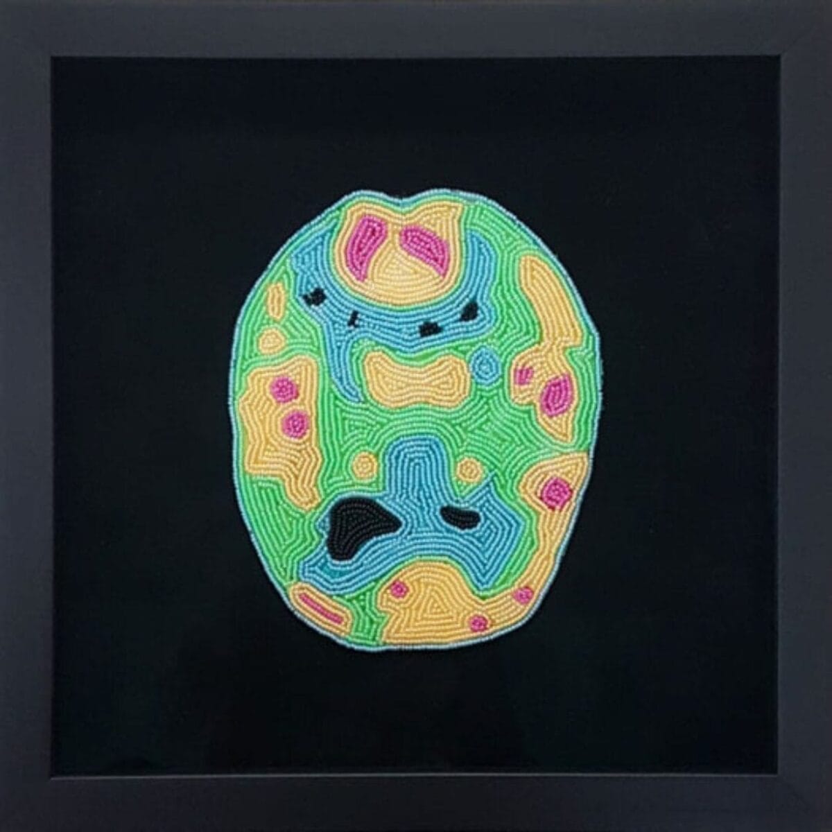 On Free Admission Day, explore a framed artwork of a beaded skull design in vibrant colors like green, yellow, pink, and blue against a black background. The piece showcases intricate patterns and varied textures, inviting you to experience its captivating artistry without cost.