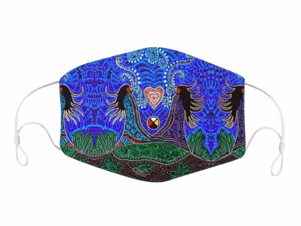A Mask with Leah Dorian Artwork features a vibrant design with four silhouetted figures holding hands, surrounded by greenery and intricate blue, green, and purple patterns. In the center, there is a multicolored circle and a glowing heart symbol above it.