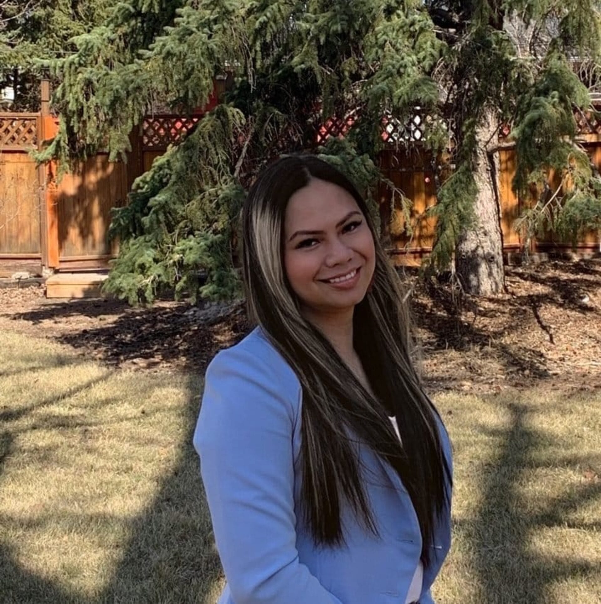 Image of Dr. Fritz Pino standing outside in front a background of grass and trees.