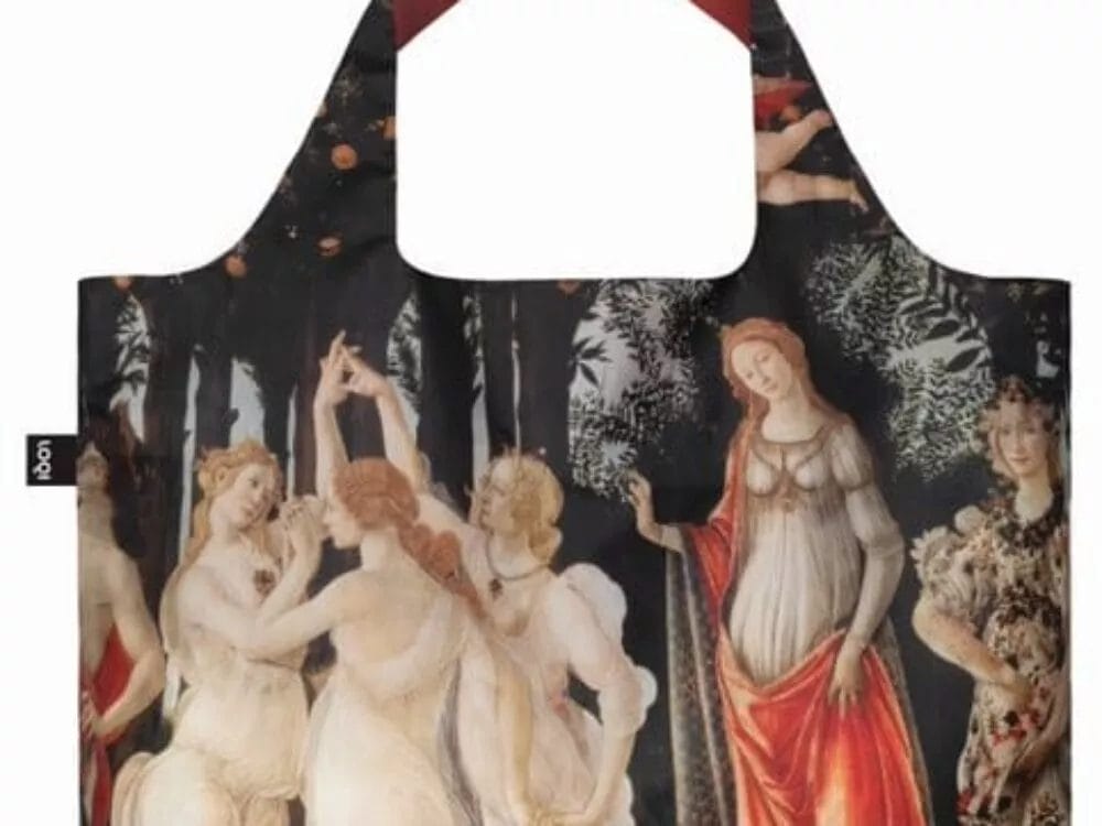 A Tote Bag with Sandro Botticelli Artwork. The bag features several mythological figures, including women in flowing dresses, set against a forest backdrop. The handles are wide and solid, contrasting in color.