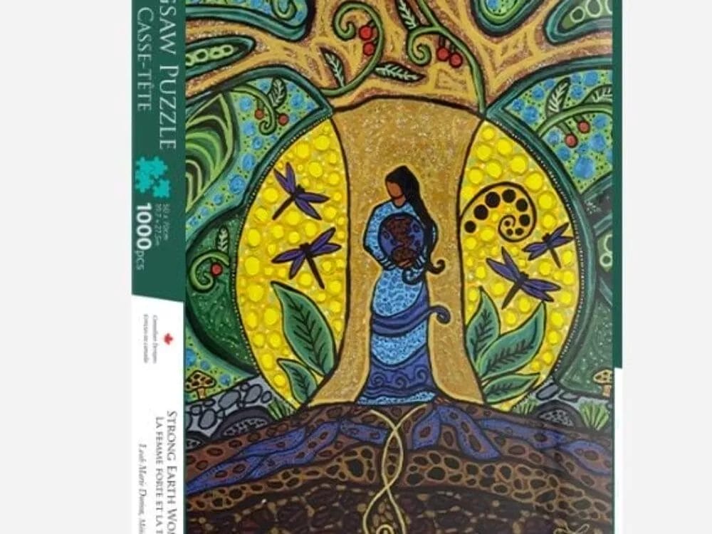 The Leah Dorion Strong Earth Women Puzzle is a 1000-piece jigsaw featuring a woman in a blue dress under a vibrant, patterned tree with dragonflies, all set among abstract nature-inspired designs.