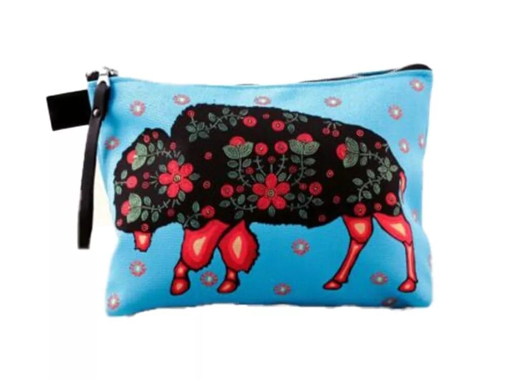 The Multi-purpose Bag - Métis Buffalo Spirit is a small blue pouch showcasing a colorful illustration of a bison, adorned with vibrant red flowers and green leaves, featuring a black zipper at the top.